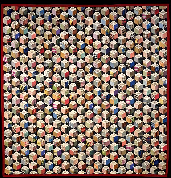 A quilt in the "Tumbling Blocks" pattern, which creates the optical illusion of a vast stack of cubes. The "tops" of the cubes all have the autographs of different luminaries of the period, including Charles Dickens, Ralph Waldo Emerson, and Abraham Lincoln.