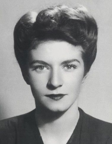 studio photo of Éliane Plewman in civvies. She is a white woman with dark hair.