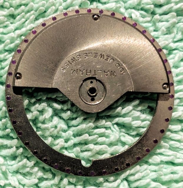Oscillating weight off a Waltham automatic watch that had 100 jewels. These jewels are just for decoration and only seen by the watchmaker