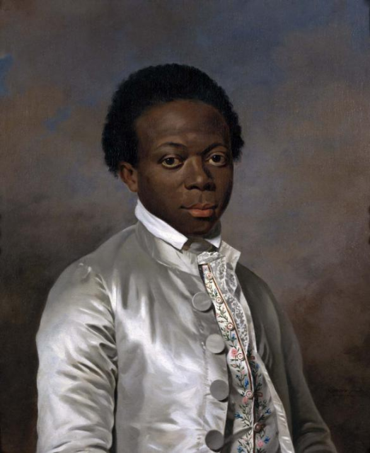 A Neoclassical portrait. A young black man, with an unenthused expression and heavy-lidded eyes, looks out at us, wearing a silver jacket with a white collar peeping over the top, and a richly embroidered vest visible through the open front of the jacket. The background is cloudy, darker toward the bottom but with patches of blue sky visible at the top.
