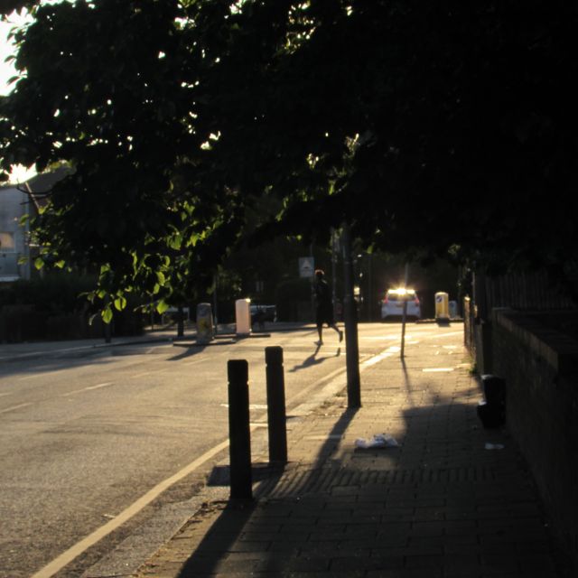 Car passes, man continues run across early morning road