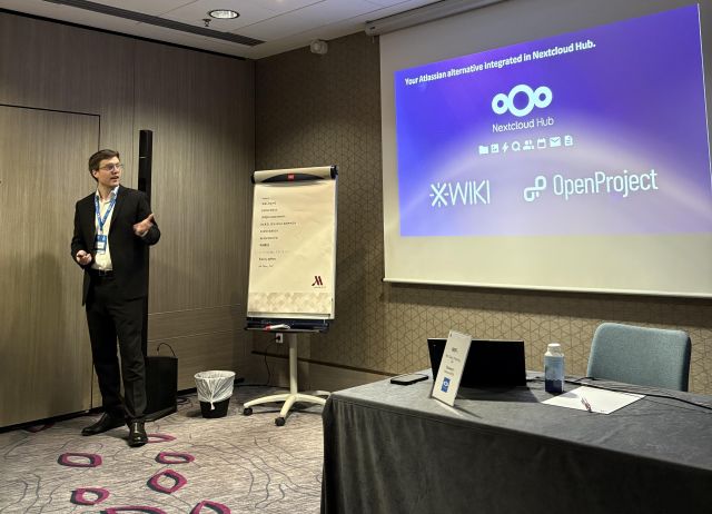 Robin Wagner presenting on stage at Nextcloud Enterprise Day 2025, discussing open-source collaboration and sovereign digital workplaces.