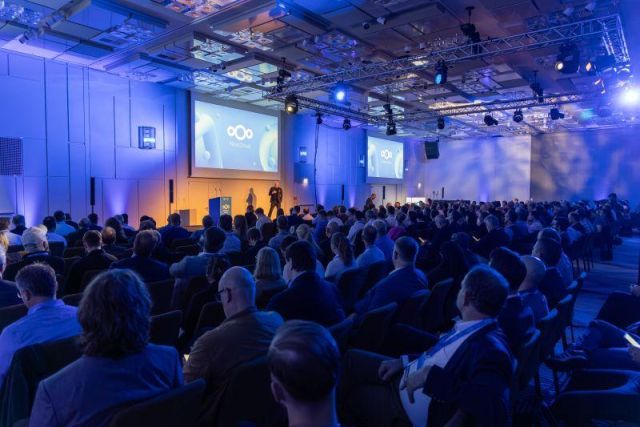 Attendees gathered in the main conference hall during the opening session of the Nextcloud Summit 2026 in Munich. The large auditorium is filled with participants listening to keynote presentations on digital sovereignty and open source technologies.