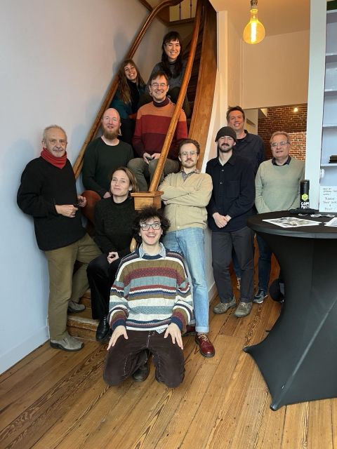 group photo at the stairs of the Internet Archive in Amsterdam with people at the cocreation workshop in Feb 2026 bringing the DTF from concept to prototype 