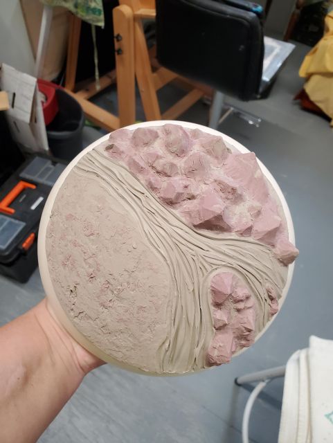 A space rock with red and grey swirled crystal mountains that shapes a wide river (that will become lava when glazed).