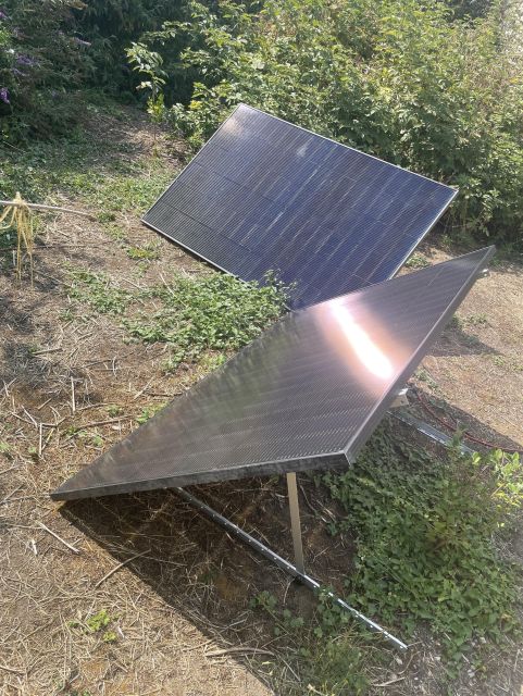 Photo of my solar panels on their supports, on the ground in my garden